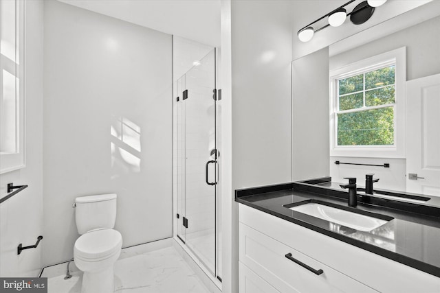 bathroom with toilet, vanity, and walk in shower