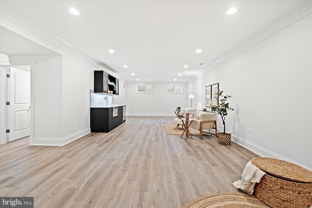 sitting room featuring crown molding and light wood-type flooring