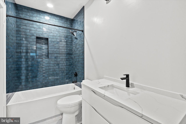 full bathroom featuring vanity, toilet, and tiled shower / bath