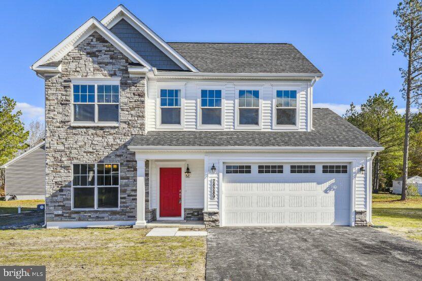 view of front of house featuring a garage and a front lawn