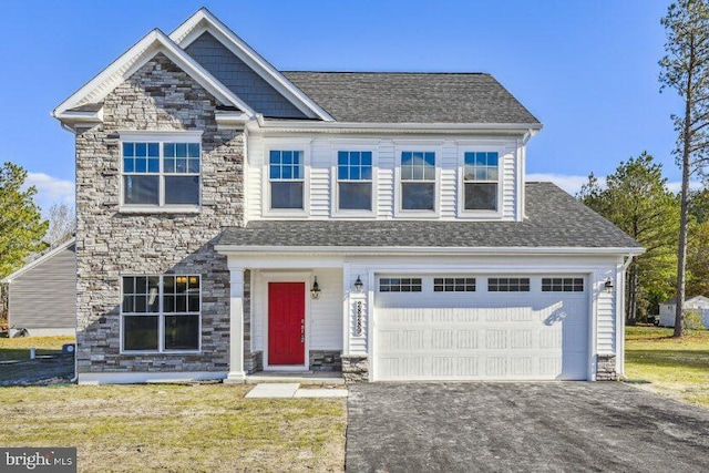 Wathen Rd, Leonardtown, MD 20650 - view of front of home featuring stone siding, driveway, a front lawn, an attached garage, and a shingled roof