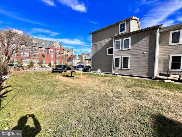 rear view of house featuring a yard