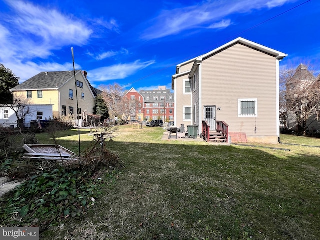 rear view of property with a lawn