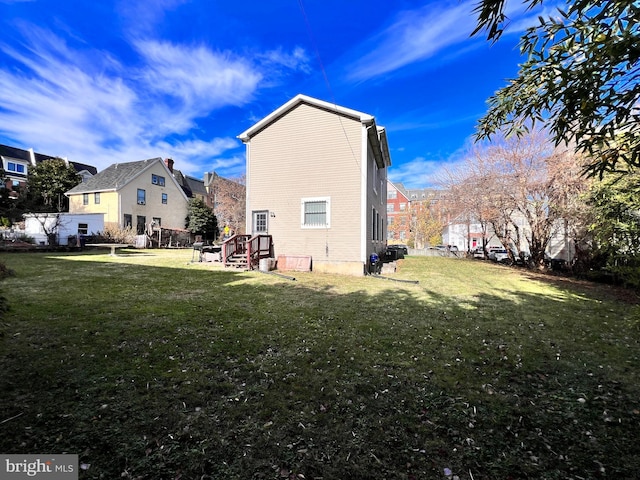 rear view of property with a yard