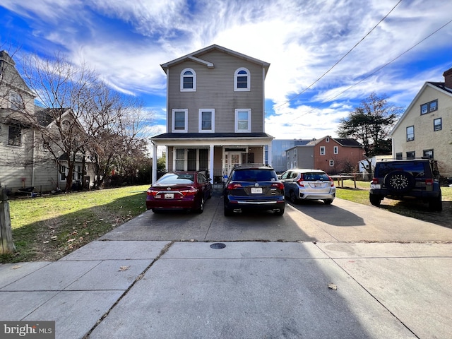 front facade with a porch and a front lawn