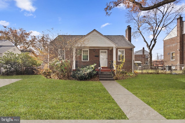 bungalow-style house with a front lawn