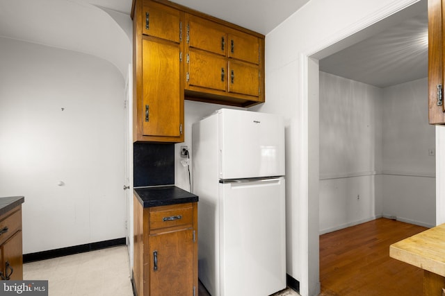 kitchen with white fridge and light wood-type flooring