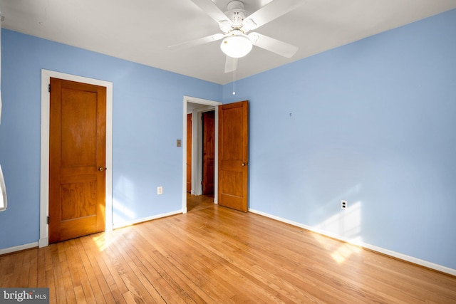 unfurnished bedroom with ceiling fan and light wood-type flooring