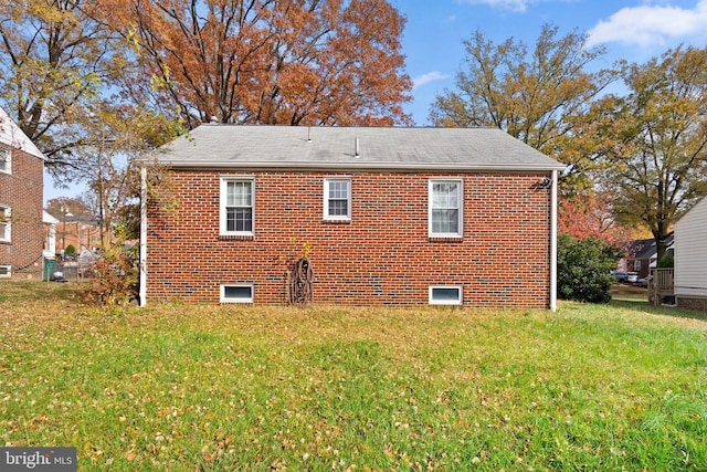 view of side of home with a lawn