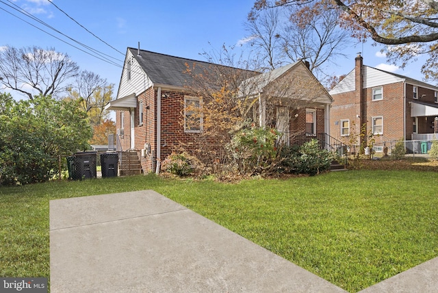 bungalow-style home with a front yard