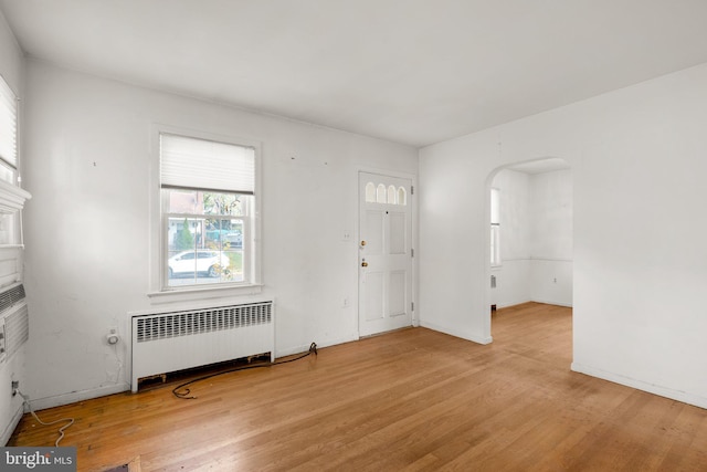 spare room featuring light hardwood / wood-style floors and radiator heating unit