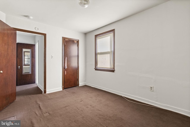 unfurnished bedroom featuring carpet flooring and multiple windows