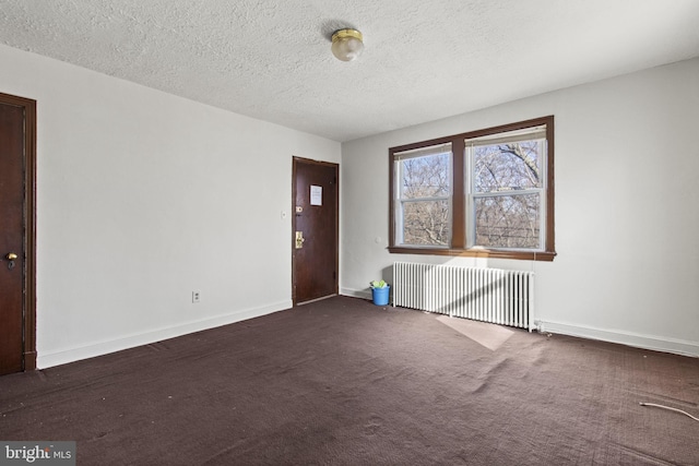 carpeted entryway with a textured ceiling and radiator