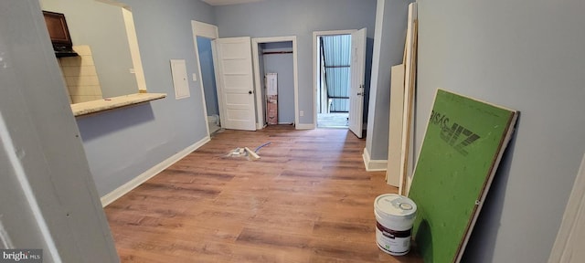 hallway with light hardwood / wood-style floors