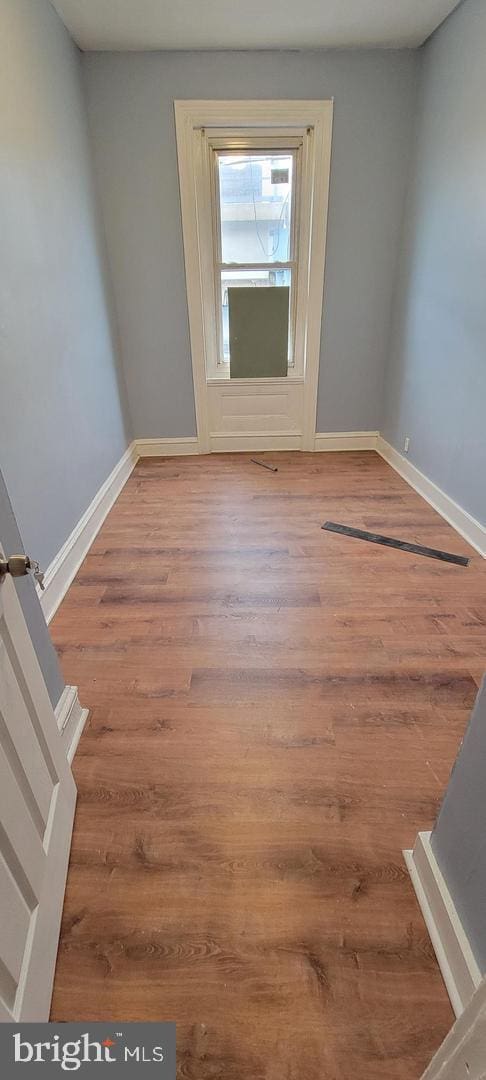 unfurnished room featuring hardwood / wood-style flooring