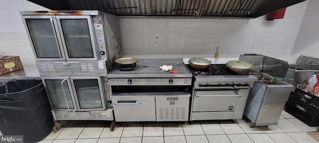 kitchen featuring high end stainless steel range and light tile patterned floors