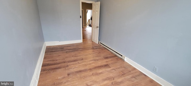 empty room featuring light hardwood / wood-style flooring and a baseboard radiator