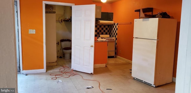 kitchen featuring decorative backsplash and white appliances