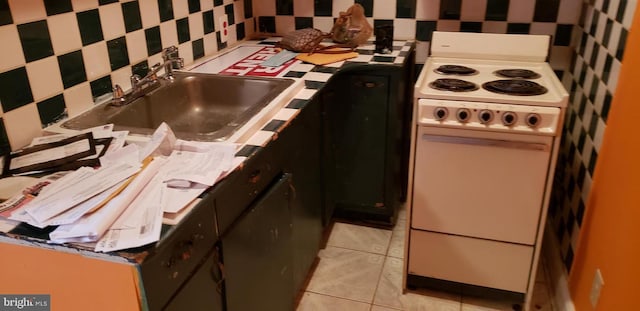 kitchen featuring sink, light tile patterned floors, and white stove