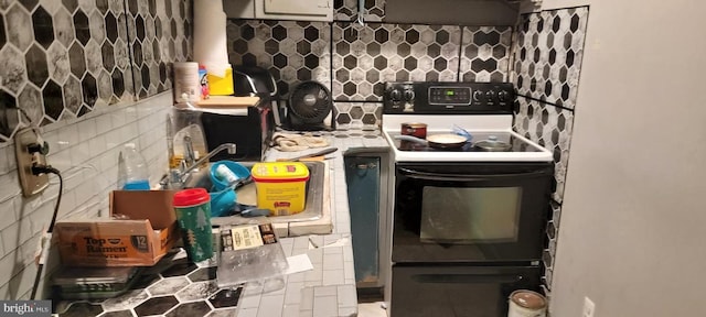 kitchen featuring decorative backsplash and white range with electric cooktop