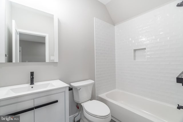 full bathroom with tiled shower / bath combo, toilet, vanity, and lofted ceiling