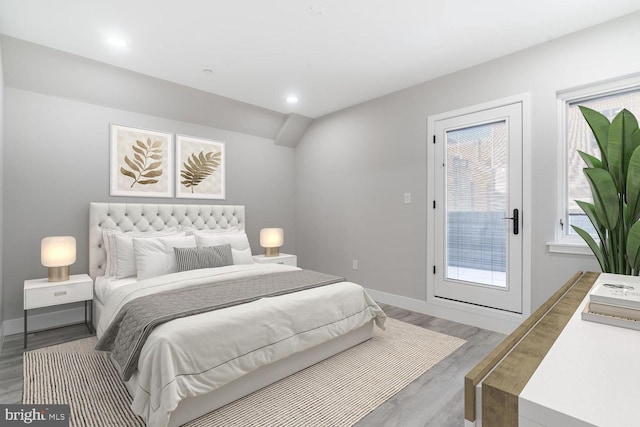 bedroom featuring wood-type flooring and access to exterior