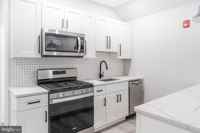 kitchen featuring white cabinets, sink, and appliances with stainless steel finishes