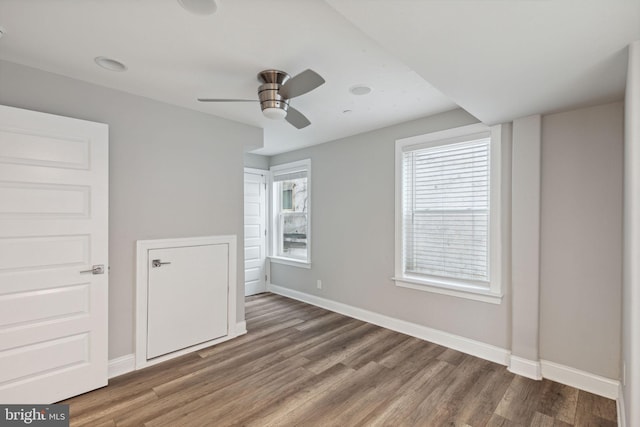 unfurnished bedroom featuring dark hardwood / wood-style flooring and ceiling fan