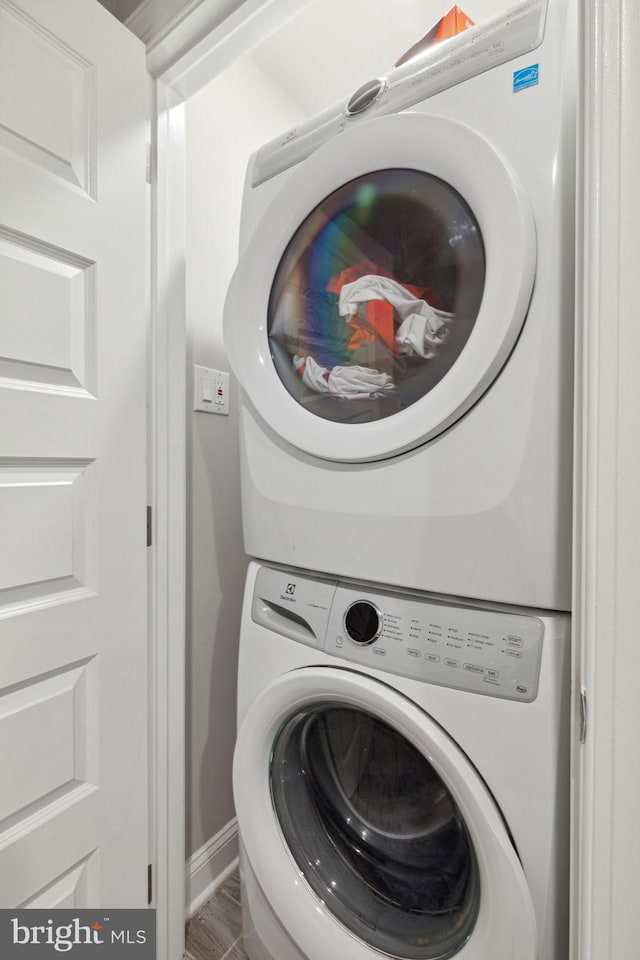 laundry area featuring stacked washer and dryer