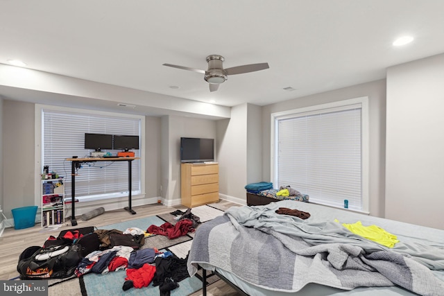 bedroom with light hardwood / wood-style floors and ceiling fan