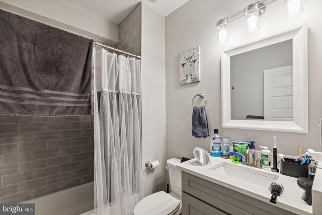 full bathroom with vanity, toilet, and shower / tub combo