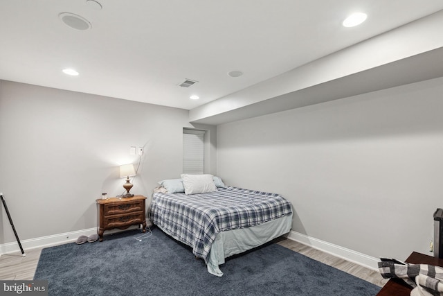 bedroom with hardwood / wood-style flooring