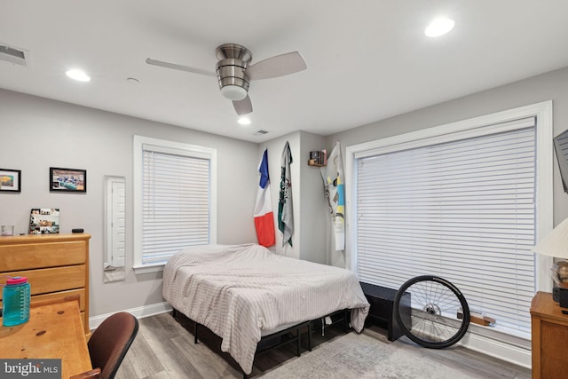 bedroom with ceiling fan and light hardwood / wood-style flooring