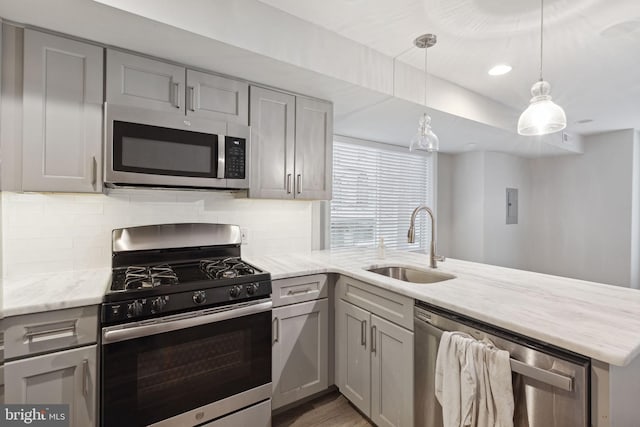 kitchen featuring gray cabinetry, sink, and appliances with stainless steel finishes