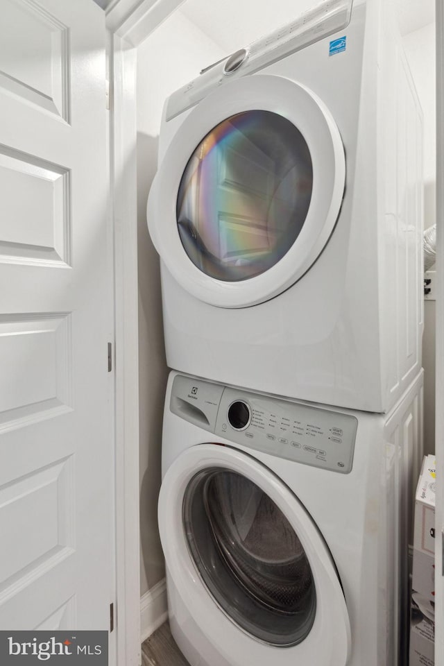 washroom with stacked washer and dryer