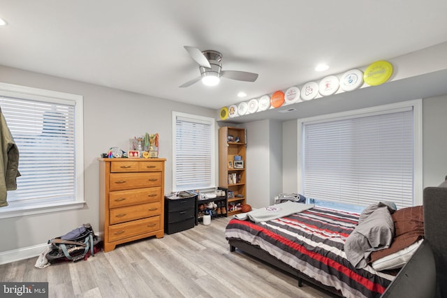 bedroom with ceiling fan and light hardwood / wood-style floors