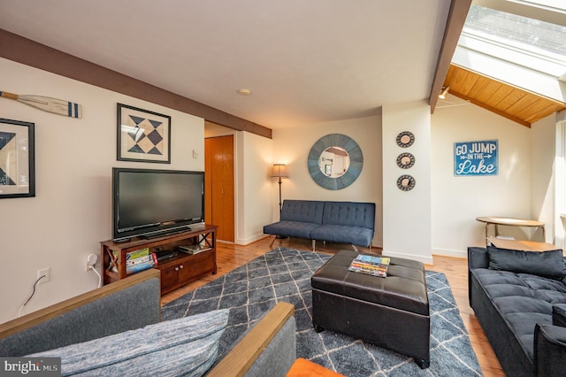 living room featuring hardwood / wood-style flooring and vaulted ceiling with beams