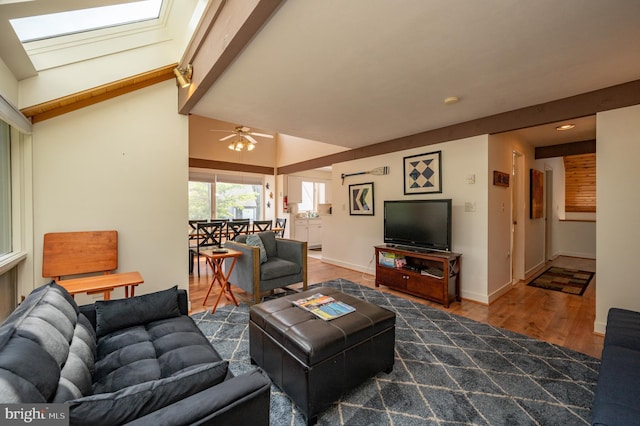 living room featuring lofted ceiling with beams and dark hardwood / wood-style flooring