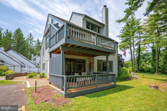 exterior space with a wooden deck and a lawn