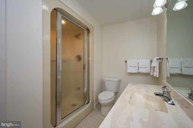 bathroom with tile patterned flooring, an enclosed shower, vanity, a textured ceiling, and toilet