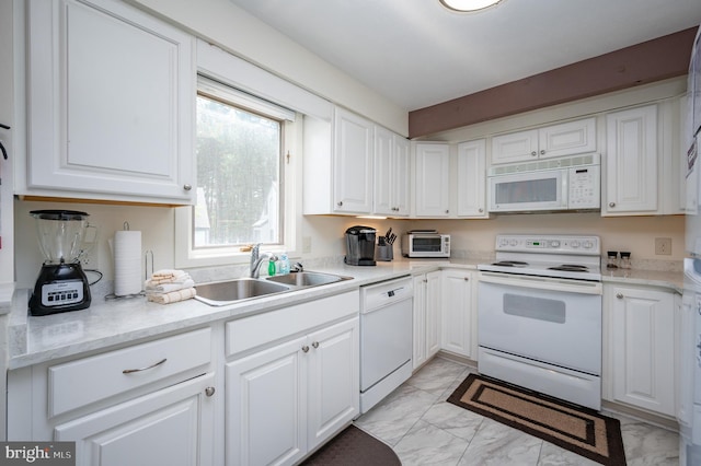 kitchen with white cabinetry, white appliances, and sink