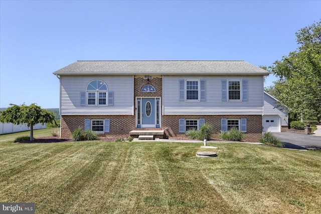 bi-level home with a front lawn