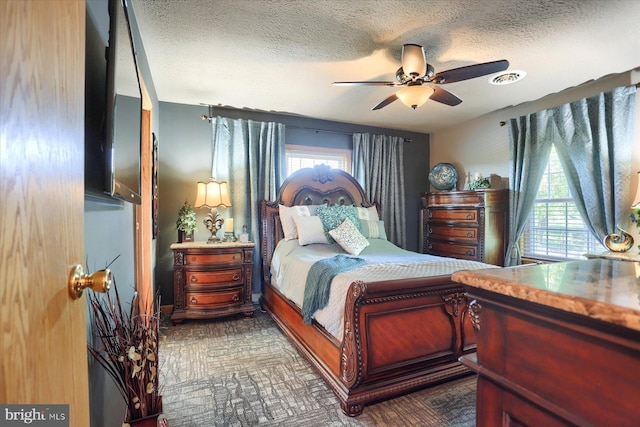 bedroom with a textured ceiling and ceiling fan