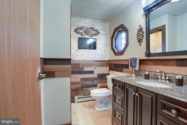 bathroom with a baseboard radiator, a textured ceiling, toilet, vanity, and tile walls