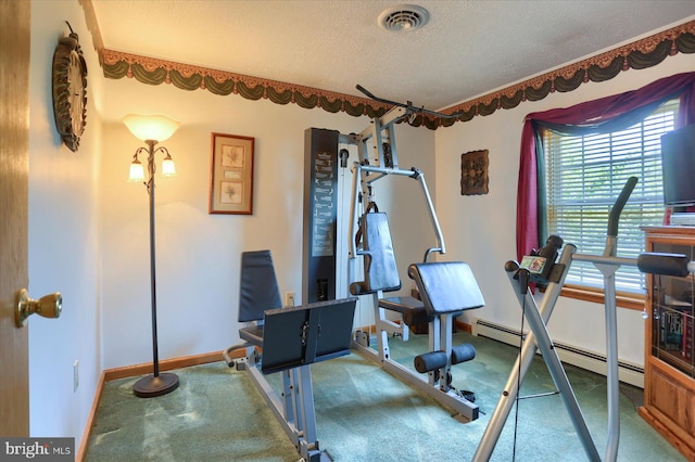 workout room with carpet, baseboard heating, and a textured ceiling