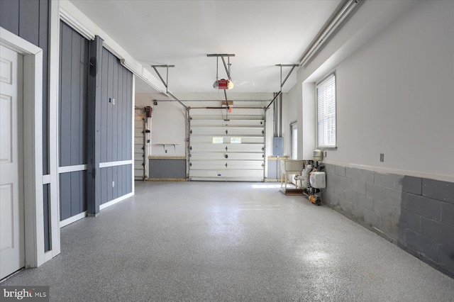 garage with electric panel and a garage door opener