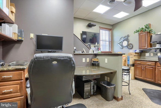 office space featuring a paneled ceiling and light colored carpet