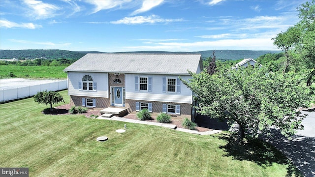 raised ranch with a mountain view and a front yard