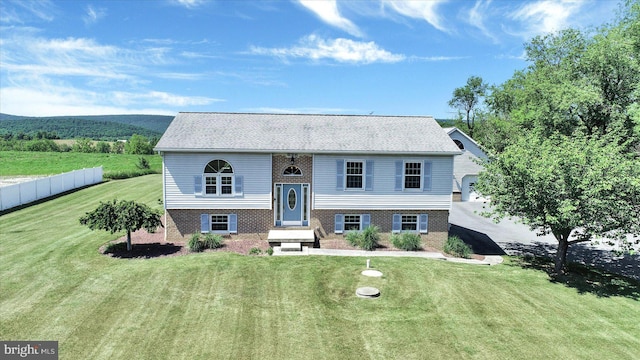 raised ranch with a front yard