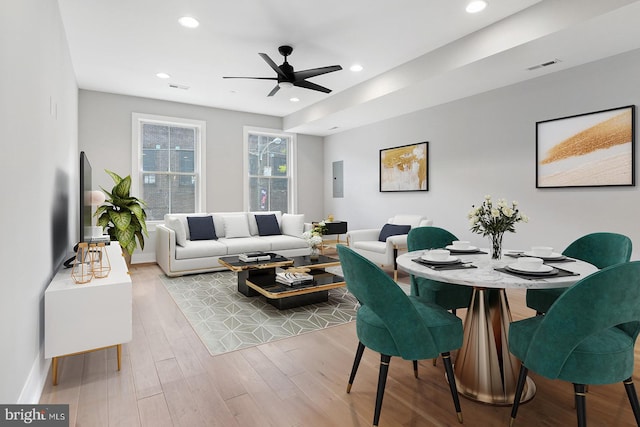 living room featuring light wood-type flooring and ceiling fan